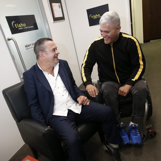 Tiaho Trust CEO Jonny Wilkinson and Wally Noble smiling together at the Tiaho Trust office.